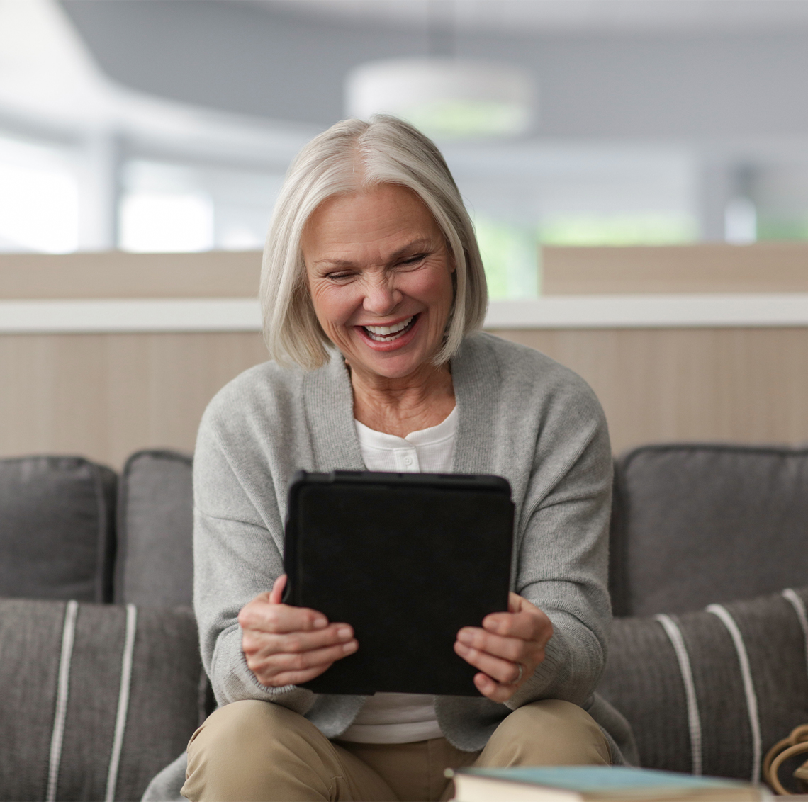 Woman smiling into a tablet device